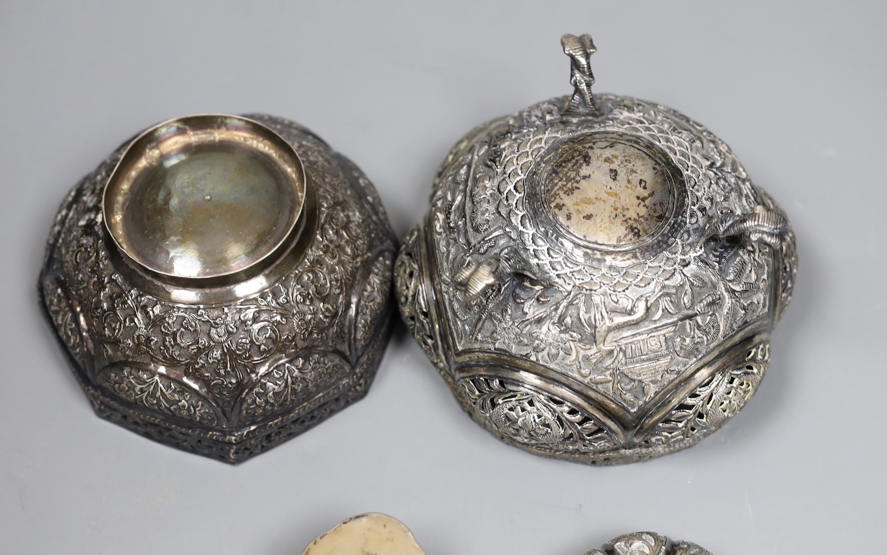Two early 20th century Indian repousse white metal bowls, widest 12cm, a similar small dish and a salt.